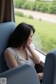 A woman sitting on a train looking out the window.